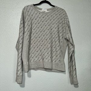 Champion pullover. Size large. It’s grey. Says champion all over.